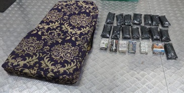 Memory cards and USB flash drives were found concealed inside a cushion in the container truck.