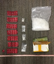 The seized suspected nimetazepam tablets (left), suspected methamphetamine (centre and top right) and suspected heroin (bottom right).