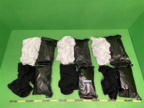 In the light of cannabis abuse among youths, Hong Kong Customs has stepped up enforcement before the summer holidays to vigorously combat smuggling of cannabis-type dangerous drugs. In June and July this year, 38 cases were detected successfully and about 291 kilograms of suspected cannabis-type dangerous drugs with an estimated market value of about $46 million were seized. Photo shows some of the suspected cannabis buds seized and the clothes used to wrap the drugs.