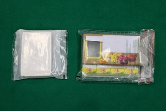 Hong Kong Customs detected two dangerous drugs cases on November 11 and 14, and seized about 8 kilograms of suspected methamphetamine and about 14kg of suspected heroin in Kwai Chung and Tin Shui Wai respectively, with a total estimated market value of about $17 million. Photo shows some of the suspected heroin seized and a box of green bean biscuits used to conceal the drugs.
