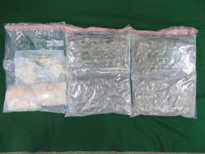 Hong Kong Customs yesterday (December 13) seized about 1.2 kilograms of suspected crack cocaine and about 2.2kg of suspected cannabis buds with a total estimated market value of about $2.2 million in Yuen Long and Tin Shui Wai. A 18-year-old man and a 17-year-old woman, both suspected to be connected with the case, were arrested. Photo shows the suspected dangerous drugs seized.