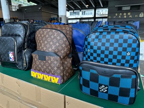 Hong Kong Customs in the past two weeks (January 3 to 16) conducted an operation codenamed "Tracer IV" to combat cross-boundary transshipments and local sales of counterfeit goods, and seized a total of about 90 000 items of suspected counterfeit goods with an estimated market value of about $40 million. Photo shows some of the suspected counterfeit branded handbags seized.