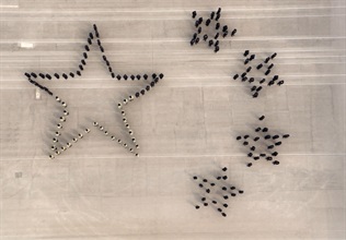 Hong Kong Customs Passing-out Parade was held today (March 24). Photo shows the parade lining up to form the "five stars" symbolising China.