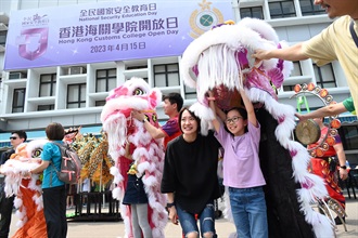 市民今日（四月十五日）在香港海關學院開放日與香港海關龍獅隊合照。