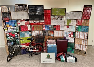 Hong Kong Customs detected two illicit cigarette cases and raided a suspected illicit cigarette storage centre while conducting anti-illicit cigarette operations in Sunny Bay and Fanling yesterday (June 8). Over 1.3 million suspected illicit cigarettes in total, with an estimated market value of about $4.9 million and a duty potential of about $3.3 million, were seized. Photo shows the suspected illicit cigarettes seized by Customs officers in Fanling, with some tools suspected to be used for distributing illicit cigarettes.