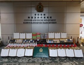 Hong Kong Customs on September 21 detected a suspected smuggling case and seized about 20 000 suspected counterfeit goods and about 3 000 bottles of suspected nicotine-containing oil for electronic cigarettes, with a total estimated market value of about $3.9 million, at the Tuen Mun River Trade Terminal Customs Cargo Examination Compound. Photo shows some of the suspected counterfeit goods and suspected nicotine-containing oil for electronic cigarettes seized.