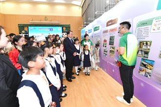 The Chief Secretary for Administration, Mr Chan Kwok-ki (front row, fourth right), today (April 14) visited the national security exhibitions in Hong Kong Customs College Open Day. Photo shows a Customs officer introducing the mission and work of Customs in safeguarding the security of the country and Hong Kong to Mr Chan.