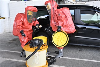 Hong Kong Customs and the Fire Services Department co-organised a counter-terrorism intelligence and hazardous material incident exercise codenamed "WOLFHUNT" this afternoon (June 24) at the Shenzhen Bay Control Point. Photo shows FSD officers wearing chemical protection suits handling hazardous material at the scene.