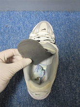 An outgoing male passenger was sentenced to fourteen months' imprisonment at the Fanling Magistrates' Courts today (February 25) for trafficking in a dangerous drug, in contravention of the Dangerous Drugs Ordinance. Photo shows the cocaine seized in the case being concealed under an insole.