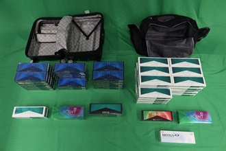 An incoming 38-year-old male passenger was sentenced to seven months and five days of imprisonment at the West Kowloon Magistrates' Courts today (April 3) for importing duty-not-paid cigarettes and failing to declare to Customs Officers, in contravention of the Dutiable Commodities Ordinance, as well as for importing alternative smoking products, in contravention of the Import and Export Ordinance. Photo shows the duty-not-paid cigarettes and alternative smoking products seized.