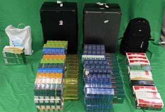 An incoming 38-year-old male passenger was sentenced to seven months and five days of imprisonment at the West Kowloon Magistrates' Courts today (April 3) for importing duty-not-paid cigarettes and failing to declare to Customs Officers, in contravention of the Dutiable Commodities Ordinance, as well as for importing alternative smoking products, in contravention of the Import and Export Ordinance. Photo shows the duty-not-paid cigarettes and alternative smoking products seized.