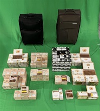 Two incoming passengers were each sentenced to four months' imprisonment and both fined $1,000 at the West Kowloon Magistrates' Courts today (May 8) for dealing with duty-not-paid tobacco and failing to declare it to Customs Officers, as well as for importing alternative smoking products, in contravention of the Dutiable Commodities Ordinance and the Import and Export Ordinance. Photo shows the duty-not-paid cigars seized from one of the incoming passengers.