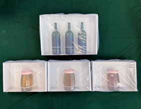 Hong Kong Customs yesterday (May 8) detected two drug trafficking cases at Kwai Chung and Hong Kong International Airport and seized about 4.5 kilograms of suspected liquid cocaine and about 30kg of suspected cannabis buds with a total estimated market value of about $10 million. Photo shows the suspected liquid cocaine seized and the wine bottles used to conceal the drugs.