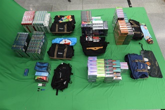 Two incoming 44-year-old male passengers were sentenced to four and six months' imprisonment respectively, with a fine of $1,000, at the West Kowloon Magistrates' Courts today (June 18) for possessing and dealing with duty-not-paid cigarettes and failing to declare them to Customs officers, as well as for importing alternative smoking products, in contravention of the Dutiable Commodities Ordinance and the Import and Export Ordinance. Photo shows the duty-not-paid cigarettes and alternative smoking products seized.
