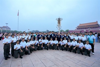 The Deputy Commissioner (Control and Enforcement) of Customs and Excise, Mr Mark Woo (second row, eleventh left); the Honorary Founding Executive Director of the Executive Committee of Customs YES, Mr Edgar Kwan (second row, tenth left);  the Executive Director, Mr Desmond Yip (second row, tenth right); the Directors, Dr Mark Mak (second row, ninth right), Mr Yang Bin (second row, eighth left) and Ms Sylvia Lee (second row, sixth right); and the Honorary Presidents of the Honorary Presidents' Association, Mr Kenneth Wong (second row, eighth right), Mr Arthur Mui (second row, ninth left) and Ms Nicole Wong (second row, seventh right), led members of the Foot Drill and Flag Party of the Customs Youth Leader Corps to witness the flag-raising ceremony at Tiananmen Square on July 3.