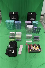 Two incoming male passengers, aged 31 and 36, were both sentenced to five months and two weeks' imprisonment and fined $1,500 at the West Kowloon Magistrates' Courts today (August 25) for possessing and dealing with duty-not-paid cigarettes and failing to declare them to Customs Officers, as well as for importing alternative smoking products, in contravention of the Dutiable Commodities Ordinance and the Import and Export Ordinance. Photo shows some of the duty-not-paid cigarettes and alternative smoking products seized.