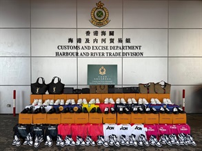 Hong Kong Customs on August 13 seized about 7 700 suspected counterfeit goods, including sneakers, bags and jerseys, with an estimated market value of about $1.27 million at the Tuen Mun River Trade Terminal Customs Cargo Examination Compound. Photo shows the suspected counterfeit goods seized.