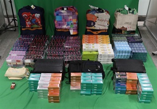A 25-year-old incoming female passenger was sentenced to eight months’ imprisonment and fined $1,000 by the West Kowloon Magistrates' Courts today (September 15) for importing duty-not-paid cigarettes and failing to declare them to Customs Officers, as well as for importing alternative smoking products, in contravention of the Dutiable Commodities Ordinance and the Import and Export Ordinance. Photo shows the duty-not-paid cigarettes and alternative smoking products seized.