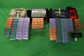 A 58-year-old incoming male passenger was sentenced to six months' imprisonment and fined $800 by the West Kowloon Magistrates' Courts today (September 18) for possessing duty-not-paid cigarettes and failing to declare to Customs Officers, as well as for importing alternative smoking products, in contravention of the Dutiable Commodities Ordinance and the Import and Export Ordinance. Photo shows the duty-not-paid cigarettes and the alternative smoking products seized.