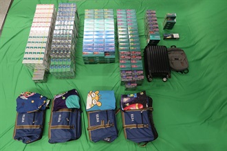 Two incoming passengers were both sentenced to eight months' imprisonment, with one passenger fined $500 and the other passenger fined $1,500, at the West Kowloon Magistrates' Courts today (September 19) for importing duty-not-paid cigarettes and failing to declare them to Customs officers, as well as for importing alternative smoking products, in contravention of the Dutiable Commodities Ordinance and the Import and Export Ordinance. Photo shows the duty-not-paid cigarettes and alternative smoking products seized.