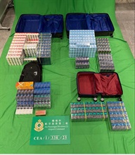 A 37-year-old incoming female passenger was sentenced to six months and eight days' imprisonment and fined $800 by the West Kowloon Magistrates' Courts today (September 22) for importing duty-not-paid cigarettes and failing to declare them to Customs officers, as well as for importing alternative smoking products, in contravention of the Dutiable Commodities Ordinance and the Import and Export Ordinance. Photo shows the duty-not-paid cigarettes and the alternative smoking products seized.