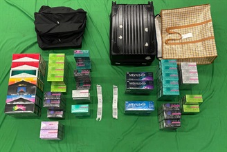 A 35-year-old incoming male passenger was sentenced to six months' imprisonment and fined $1,500 by the West Kowloon Magistrates' Courts today (September 30) for importing duty-not-paid cigarettes and failing to declare them to Customs officers, as well as for importing alternative smoking products, in contravention of the Dutiable Commodities Ordinance and the Import and Export Ordinance. Photo shows the duty-not-paid cigarettes and alternative smoking products seized.