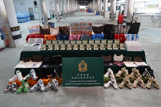 Hong Kong Customs conducted an enforcement operation with the Mainland and Macao Customs from September 15 to 30, during which inspections of goods across the three places and destined for America, Europe, Japan and Korea were stepped up, to combat cross-boundary and transshipment counterfeiting activities. During the operation, Hong Kong Customs detected 18 cases and seized about 45 000 suspected counterfeit goods, including watches, handbags, footwear and fragrances, with a total estimated market value of about $21 million. Photo shows some of the suspected counterfeit goods seized.