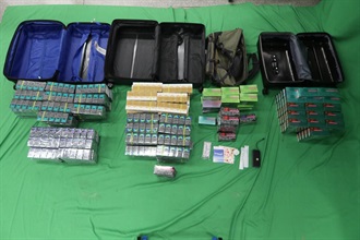 A 29-year-old incoming male passenger was sentenced to four months' imprisonment and fined $1,000 by the West Kowloon Magistrates' Courts today (October 24) for importing duty-not-paid cigarettes and failing to declare them to Customs officers, as well as for importing alternative smoking products, in contravention of the Dutiable Commodities Ordinance and the Import and Export Ordinance. Photo shows the duty-not-paid cigarettes and alternative smoking products seized.