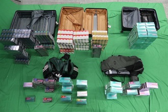 A 30-year-old incoming male passenger was sentenced to five months' imprisonment and fined $1,000 by the West Kowloon Magistrates' Courts today (October 24) for importing duty-not-paid cigarettes and failing to declare them to Customs officers, as well as for importing alternative smoking products, in contravention of the Dutiable Commodities Ordinance and the Import and Export Ordinance. Photo shows the duty-not-paid cigarettes and alternative smoking products seized.