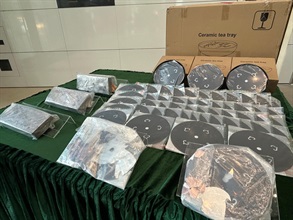 Hong Kong Customs detected two air freight smuggling cases of suspected precious metal on October 3 and 16, and seized about 60 kilograms of gold-silver alloy and about 80kg of suspected gold, with a total estimated market value of about $100 million, at Hong Kong International Airport. Photo shows three suspected gold cuboids with metal coating on the exterior (left) and gold-silver alloy discs seized from ceramic tea trays (right).