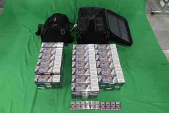 One incoming 42-year-old male passenger was sentenced to three months’ imprisonment and fined $1,000 by the West Kowloon Magistrates' Courts today (December 30) for importing duty-not-paid cigarettes and failing to declare them to Customs officers, in contravention of the Dutiable Commodities Ordinance. Photo shows the duty-not-paid cigarettes seized.