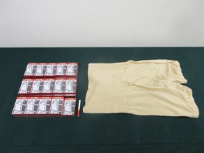 A 67 year-old incoming female passenger was sentenced to two months' imprisonment and fined $2,000 by the Fanling Magistrates' Courts today (January 14) for possessing duty-not-paid cigarettes and failing to declare them to Customs officers, in contravention of the Dutiable Commodities Ordinance. Photo shows the duty-not-paid cigarettes seized and the clothing used to conceal the duty-not-paid cigarettes.