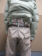 A 66-year-old incoming male passenger was sentenced to two months' imprisonment and fined $2,000 by the Fanling Magistrates' Courts today (January 14) for possessing duty-not-paid cigarettes and failing to declare them to Customs officers, in contravention of the Dutiable Commodities Ordinance. Photo shows the man concealing the duty-not-paid cigarettes around his waist area.
