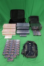 An incoming female passenger was sentenced to six months' imprisonment and fined $500 by the West Kowloon Magistrates' Courts today (February 12) for importing alternative smoking products, importing duty-not-paid cigarettes and failing to declare them to Customs officers, in contravention of the Import and Export Ordinance and the Dutiable Commodities Ordinance. Photo shows the alternative smoking products and duty-not-paid cigarettes seized from the personal baggage of the 31-year-old female passenger.