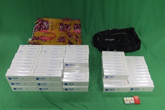 Hong Kong Customs recently mounted enforcement operations targeting large-scale illicit cigarette smuggling activities by sea and detected two cases on January 31 and February 4, during which a total of about 15.22 million suspected illicit cigarettes with an estimated market value of about $68 million and a duty potential of about $50 million were seized. Eight men were arrested. Photo shows the suspected illicit cigarettes seized at the Kwai Chung Customhouse Cargo Examination Compound on February 4.