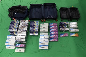 Two incoming passengers were both sentenced to four months' imprisonment and fined $3,000 by the West Kowloon Magistrates' Courts today (February 25) for dealing with and possessing duty-not-paid cigarettes and failing to declare them to Customs officers, in contravention of the Dutiable Commodities Ordinance. Photo shows the duty-not-paid cigarettes seized from the personal baggage of one of the incoming passengers, a 40-year-old female.