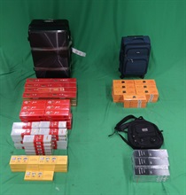 Two incoming passengers were both sentenced to five months' imprisonment and fined $1,000 by the Kowloon City Magistrates' Courts today (March 7) for importing and possessing duty-not-paid cigarettes and failing to declare them to Customs officers, in contravention of the Dutiable Commodities Ordinance. Photo shows the duty-not-paid cigarettes seized from the personal baggage of a 52-year-old incoming male passenger.