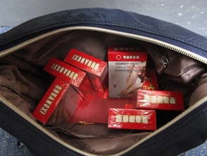 An incoming female passenger was sentenced to 12 weeks' imprisonment and fined $3,000 by the Fanling Magistrates' Courts today (March 18) for possessing duty-not-paid cigarettes and failing to declare them to Customs officers, in contravention of the Dutiable Commodities Ordinance. Photo shows the duty-not-paid cigarettes contained in the personal baggage carried by the passenger.