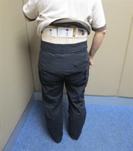 Two incoming passengers were each sentenced to six weeks' imprisonment with a fine of $3,000 by the Fanling Magistrates' Courts today (March 19) for possessing duty-not-paid cigarettes and failing to declare them to Customs officers in contravention of the Dutiable Commodities Ordinance. Photo shows a 48-year-old incoming female passenger with duty-not-paid cigarettes concealed around her waist.