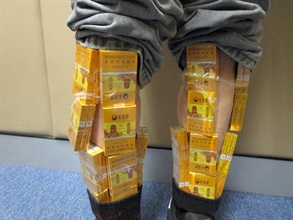 Two incoming passengers were each sentenced to six weeks' imprisonment with a fine of $3,000 by the Fanling Magistrates' Courts today (March 19) for possessing duty-not-paid cigarettes and failing to declare them to Customs officers in contravention of the Dutiable Commodities Ordinance. Photo shows a 56-year-old incoming male passenger with duty-not-paid cigarettes concealed around his calves.