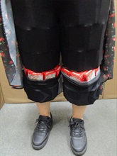 Two incoming passengers were respectively sentenced to eight weeks' imprisonment with a fine of $4,000 and four weeks’ imprisonment with a fine of $2,000 by the Fanling Magistrates' Courts today (March 20) for importing duty-not-paid cigarettes and failing to declare them to Customs officers, in contravention of Dutiable Commodities Ordinance. Photo shows a 36-year-old incoming female passenger with duty-not-paid cigarettes concealed in a pair of leggings.