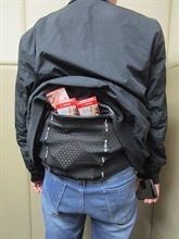 Two incoming passengers were respectively sentenced to eight weeks' imprisonment with a fine of $4,000 and four weeks’ imprisonment with a fine of $2,000 by the Fanling Magistrates' Courts today (March 20) for importing duty-not-paid cigarettes and failing to declare them to Customs officers, in contravention of Dutiable Commodities Ordinance. Photo shows a 38-year-old incoming male passenger with duty-not-paid cigarettes concealed in a waistband.