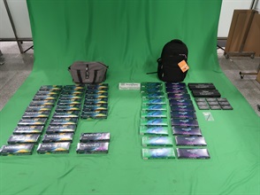 Two incoming passengers were sentenced to six months' imprisonment and fined $500, and two months' imprisonment and fined $1,000 respectively by the West Kowloon Magistrates' Courts today (March 25) for importing duty-not-paid cigarettes and failing to declare them to Customs officers, in contravention of the Dutiable Commodities Ordinance. Photo shows the duty-not-paid cigarettes seized from the personal baggage of a 38-year-old female incoming passenger.