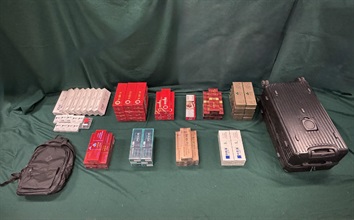 Four incoming passengers were sentenced to three months' imprisonment and a fine of $4,000, two months' imprisonment with a fine of $2,000 and two months’ imprisonment with a fine of $5,000 respectively by the Fanling Magistrates' Courts today (March 30) for possessing or importing duty-not-paid cigarettes and failing to declare them to Customs officers, in contravention of Dutiable Commodities Ordinance. Photo shows the duty-not-paid cigarettes seized from the personal baggage of a 27-year-old incoming male passenger.