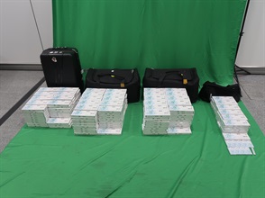 Three incoming passengers were sentenced to seven to eight months' imprisonment and fined $1,000 each by the West Kowloon Magistrates' Courts today (April 20) for importing and possessing duty-not-paid cigarettes and failing to declare them to Customs officers, in contravention of the Dutiable Commodities Ordinance. Photo shows the duty-not-paid cigarettes seized from the personal baggage of a 30-year-old incoming male passenger at Hong Kong International Airport.