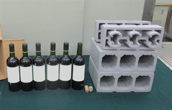 Hong Kong Customs and the Macao Judiciary Police conducted a joint operation in January this year to combat transnational drug trafficking activities. A total of about 7.5 litres of suspected liquid cocaine with an estimated market value of about $9.7 million (worth about MOP25 million in Macao) were seized. Photo shows some of the seized suspected liquid cocaine concealed inside wine bottles.