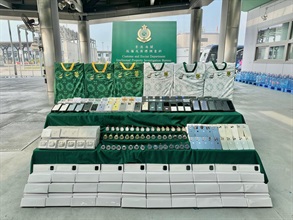 Hong Kong Customs conducted an enforcement operation with the Mainland and Macao Customs from April 13 to April 24, during which inspections of goods across the three places and destined for countries in the Americas, Europe, Middle East, Africa and Southeast Asia were stepped up, with a view to combating cross-boundary and transshipment counterfeiting activities. During the operation, Hong Kong Customs detected 23 cases and seized about 46 000 suspected counterfeit goods, including watches, mobile phones, bags, clothing, footwear and electronic products etc, with a total estimated market value of about $16 million. Photo shows the suspected counterfeit goods seized.
