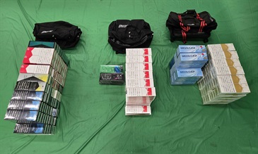 Two incoming passengers were sentenced to six months' imprisonment with a fine of $1,000, and five months' imprisonment with a fine of $1,000 respectively by the West Kowloon Magistrates' Courts today (May 26) for importing duty-not-paid cigarettes and failing to declare them to Customs officers, in contravention of the Dutiable Commodities Ordinance. Photo shows the duty-not-paid cigarettes seized from the personal baggage of a 36-year-old incoming male passenger.