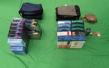 Two incoming passengers were sentenced to six months' imprisonment with a fine of $1,000, and five months' imprisonment with a fine of $1,000 respeWest Kowloon Magistrates' Courts today (May 26) for importing duty-not-paid cigarettes and failing to declare them to Customs officers, in contravention of the Dutiable Commodities Ordinance. Photo shows the duty-not-paid cigarettes seized from the personal baggage of a 44-year-old incoming male passenger.