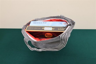 Two incoming passengers were each sentenced to four weeks' imprisonment with a fine of $1,000 by the Fanling Magistrates' Courts today (June 8) for possessing duty-not-paid cigarettes and failing to declare them to Customs officers in contravention of the Dutiable Commodities Ordinance. Photo shows the duty-not-paid cigarettes seized from the personal baggage of the 50-year-old incoming female passenger.